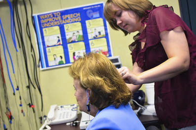 clinician performing hearing assessment