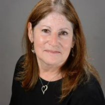 Woman with brown hair wearing a black shirt