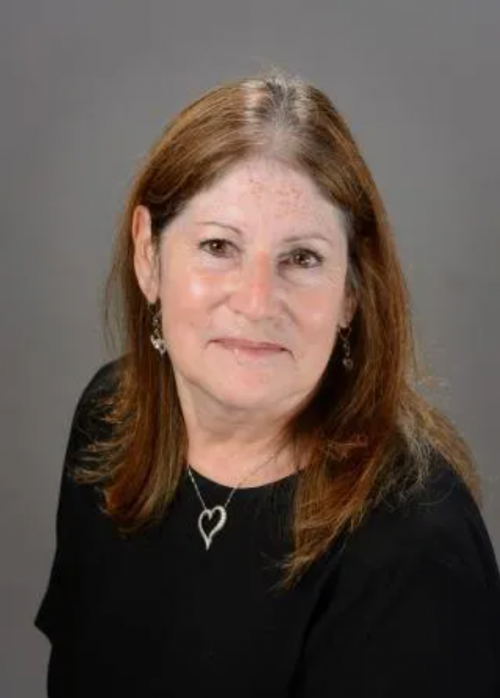 Woman with brown hair wearing a black shirt