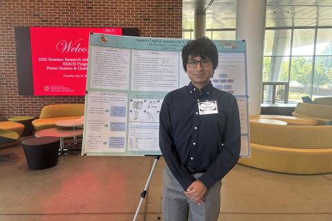 Andre Guadalupe posing next to her poster at the 2025 Poster Session