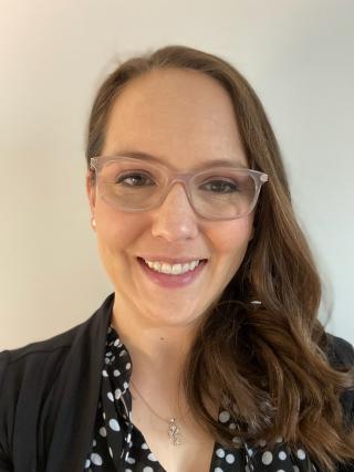 a woman with brown hair and glasses